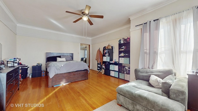 bedroom with hardwood / wood-style flooring, ceiling fan, and ornamental molding