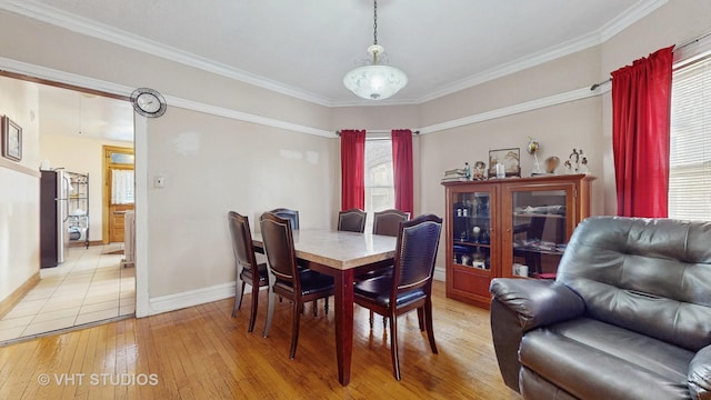 dining room featuring ornamental molding and light hardwood / wood-style floors