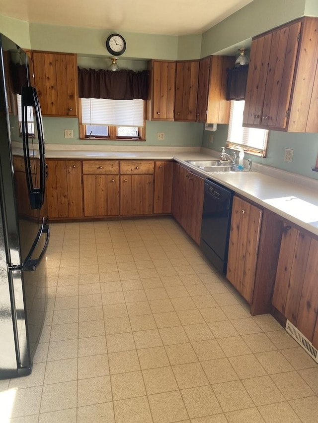 kitchen featuring sink and black appliances