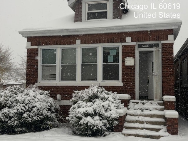 view of snow covered property entrance