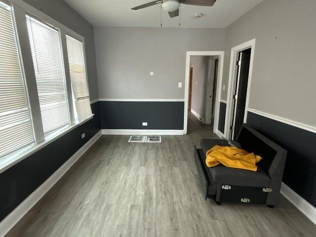 empty room featuring light wood-type flooring and ceiling fan