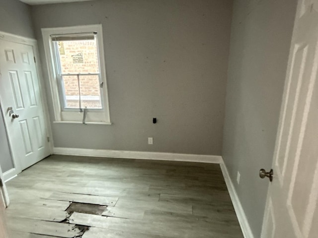 unfurnished room with wood-type flooring