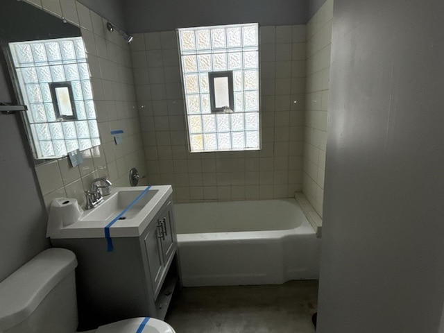 full bathroom with vanity, toilet, and tiled shower / bath combo