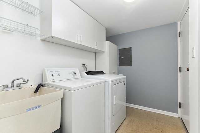 washroom featuring sink, cabinets, electric panel, and washer and dryer