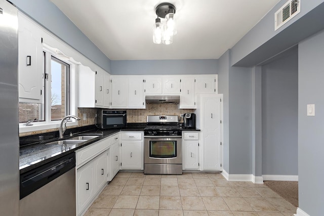 kitchen with sink, light tile patterned flooring, white cabinets, and appliances with stainless steel finishes