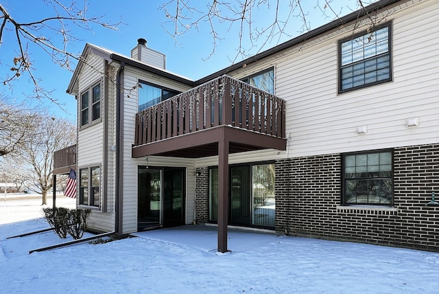 snow covered house with a balcony