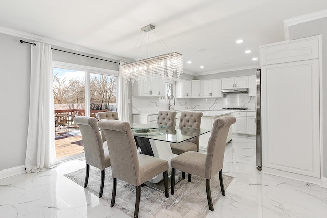 dining area with sink and crown molding