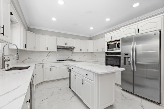 kitchen featuring appliances with stainless steel finishes, a kitchen island, sink, backsplash, and light stone counters