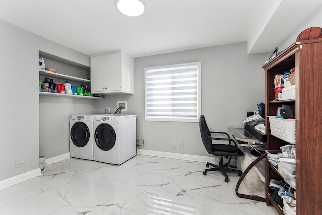 clothes washing area with cabinets and washing machine and dryer