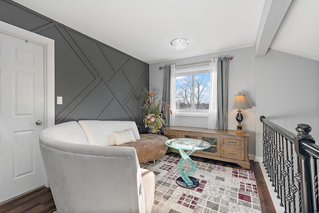 living area with dark wood-type flooring and beamed ceiling