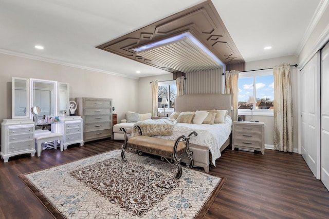 bedroom featuring ornamental molding, a closet, and dark hardwood / wood-style flooring