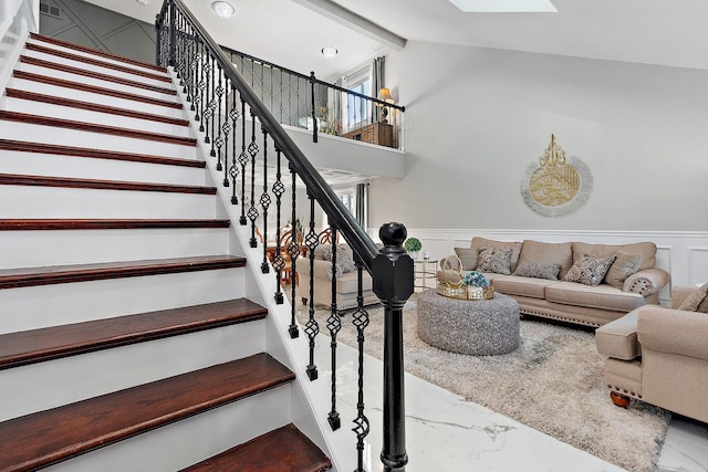 stairway featuring a skylight