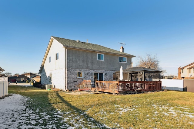 back of house featuring a wooden deck, a gazebo, and a yard