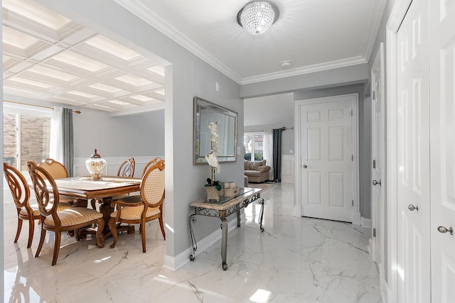 dining room with coffered ceiling and ornamental molding