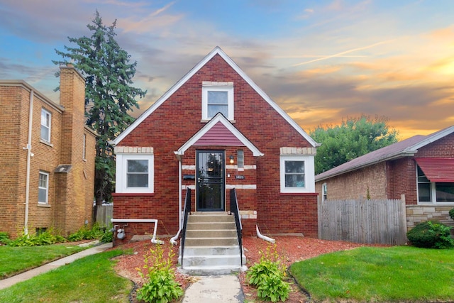 bungalow-style house featuring a yard