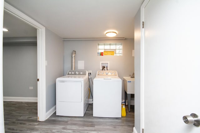 laundry room with dark hardwood / wood-style flooring and washing machine and clothes dryer