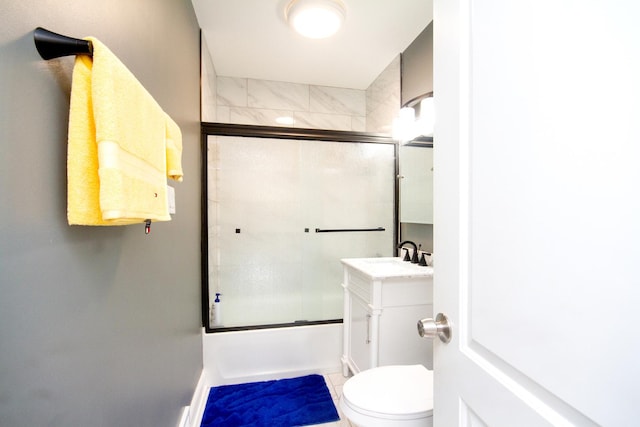 full bathroom with toilet, enclosed tub / shower combo, and vanity