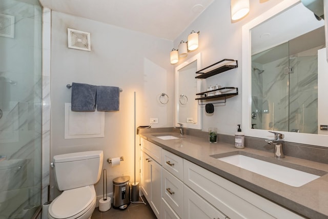 bathroom featuring vanity, toilet, a shower with shower door, and tile patterned flooring