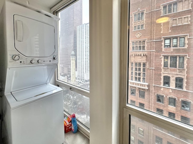 laundry room with stacked washer and dryer