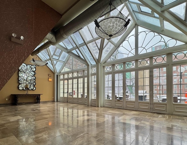 unfurnished sunroom featuring vaulted ceiling