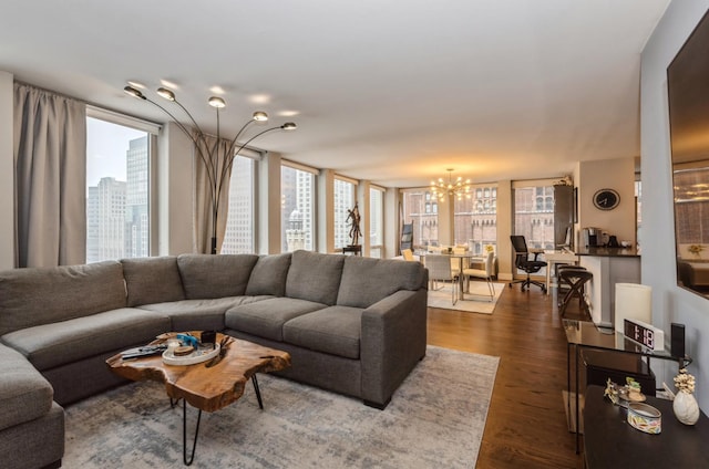 living room featuring a notable chandelier and dark hardwood / wood-style flooring