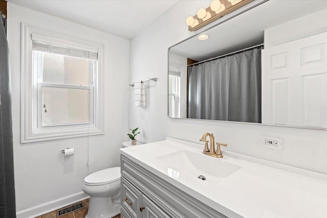 bathroom featuring toilet, a shower with shower curtain, tile patterned floors, and vanity