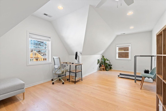 office space with vaulted ceiling, a wealth of natural light, and light hardwood / wood-style flooring