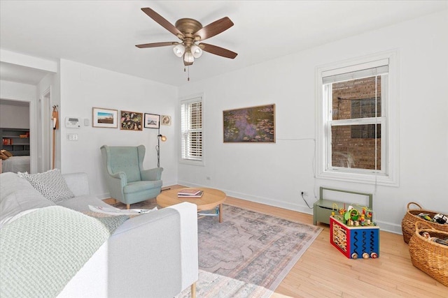 living room with hardwood / wood-style flooring and ceiling fan