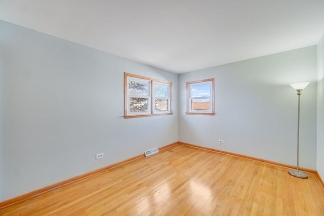 spare room with light wood-type flooring