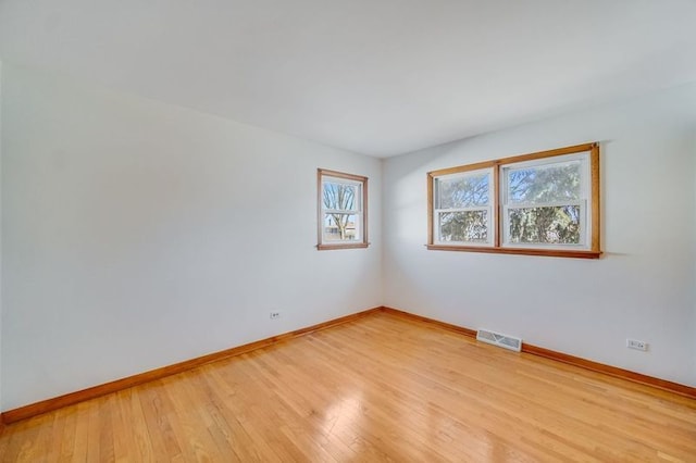 spare room featuring light hardwood / wood-style floors