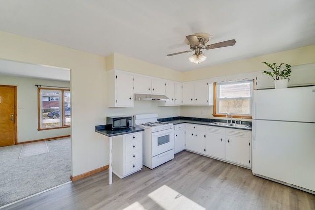 kitchen featuring white appliances, light hardwood / wood-style floors, white cabinetry, sink, and ceiling fan