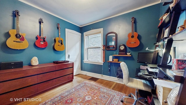 office with crown molding and light hardwood / wood-style flooring