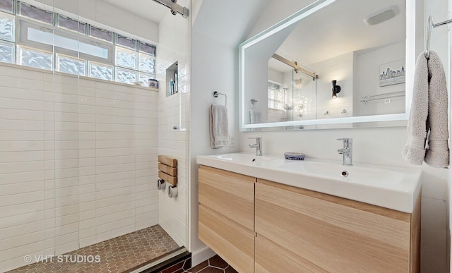 bathroom featuring vanity and a tile shower