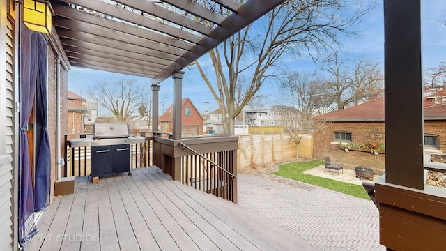 deck featuring a grill, a pergola, and a patio