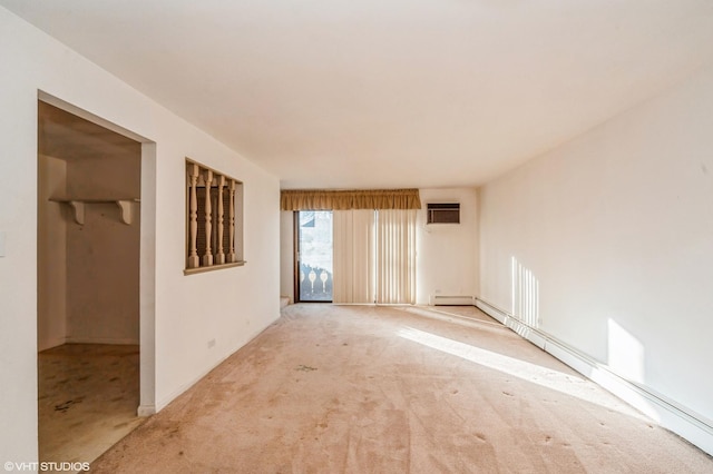 spare room featuring a wall mounted AC, light colored carpet, and baseboard heating