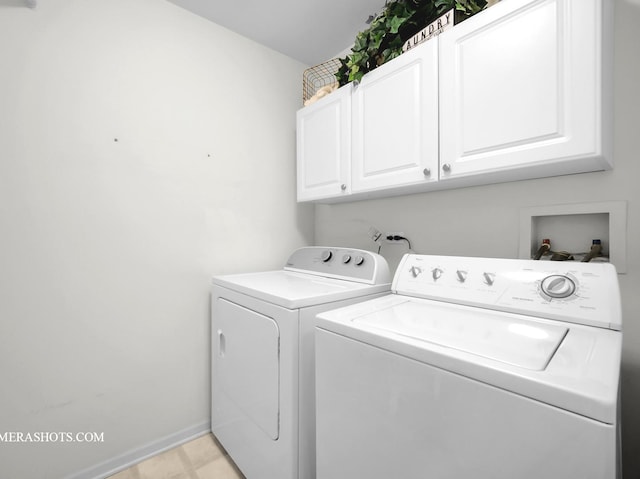 washroom with independent washer and dryer and cabinets