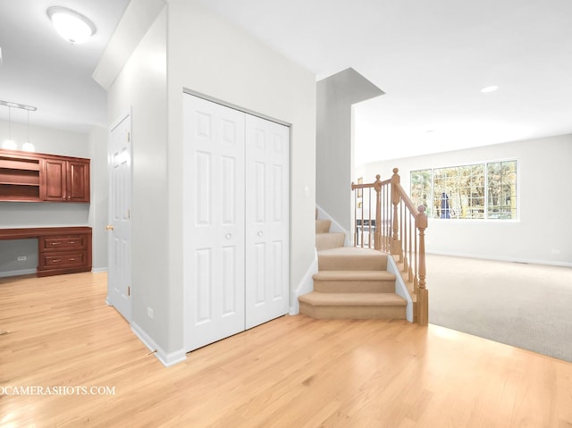 interior space with built in desk and wood-type flooring