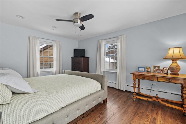 bedroom featuring ceiling fan, dark wood-type flooring, and a baseboard radiator