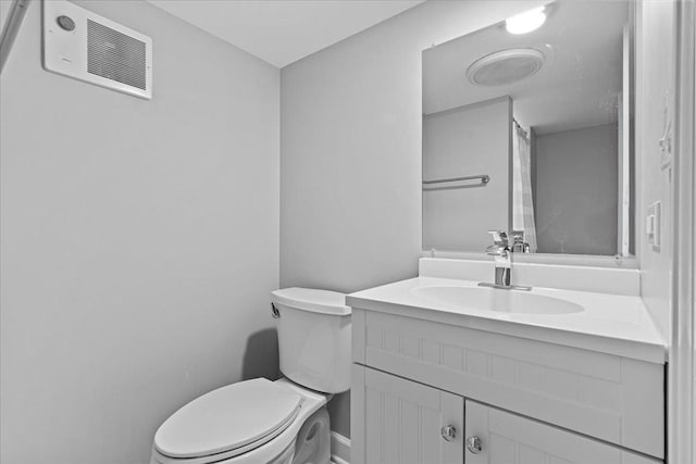 bathroom featuring toilet and vanity