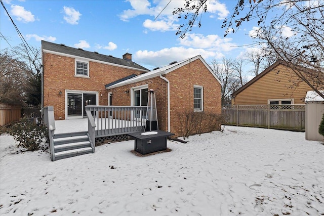 snow covered property featuring a deck