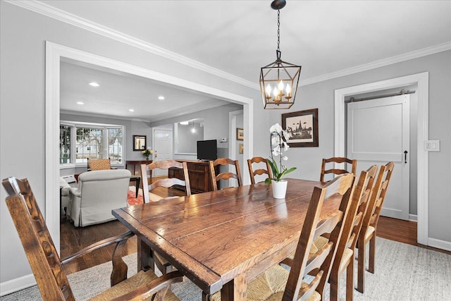 dining space with dark wood-type flooring and ornamental molding