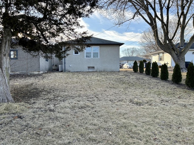 back of house with stucco siding