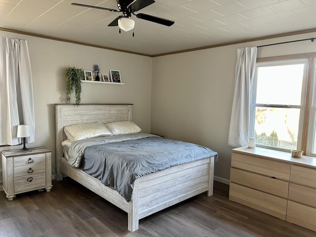 bedroom featuring ceiling fan, dark wood-type flooring, and crown molding