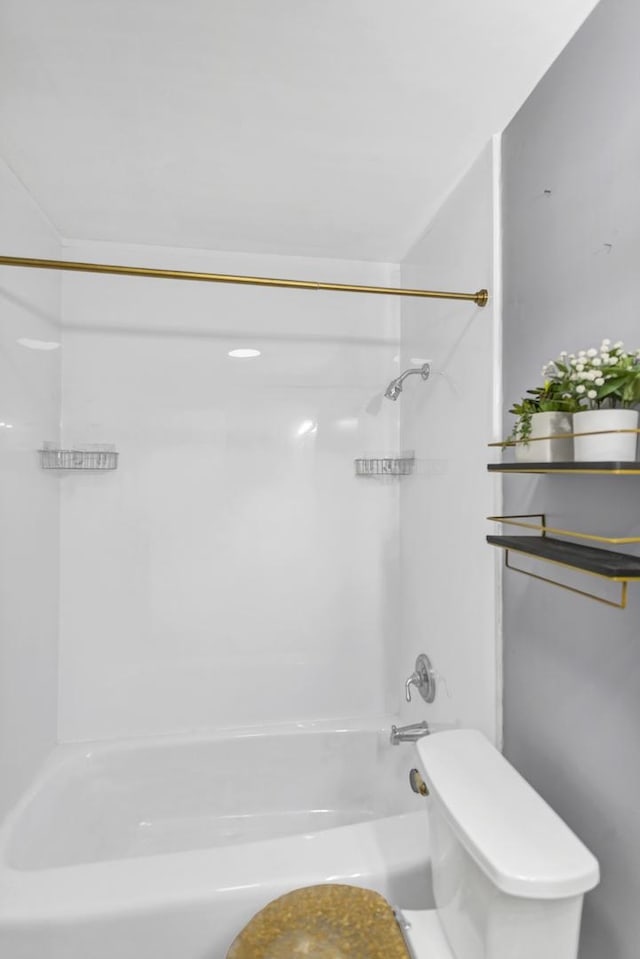 bathroom featuring bathtub / shower combination and toilet