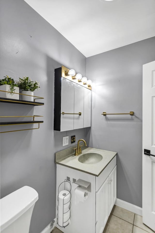 bathroom featuring tile patterned floors, vanity, and toilet