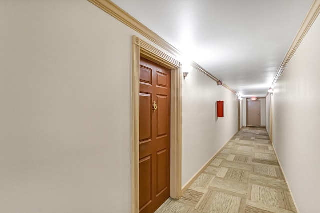 corridor featuring ornamental molding and light parquet flooring