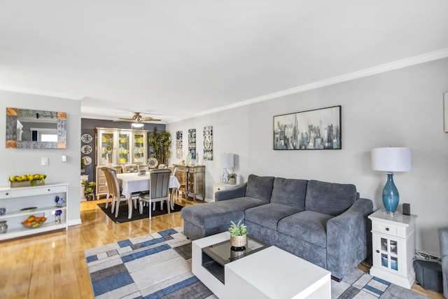 living room with crown molding, hardwood / wood-style floors, and ceiling fan