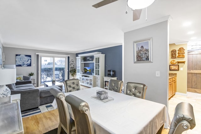 dining room featuring crown molding, ceiling fan, and light wood-type flooring