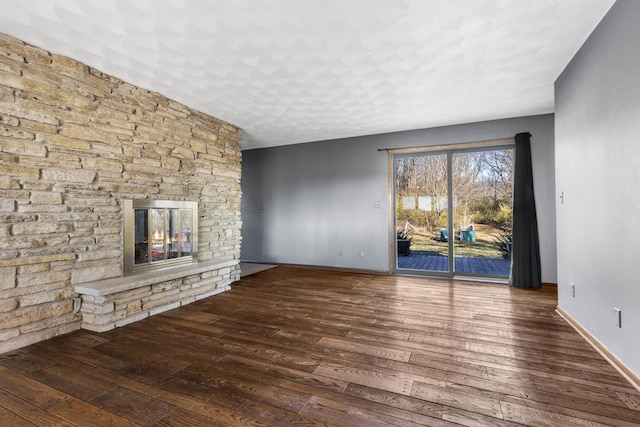 unfurnished living room with a fireplace and hardwood / wood-style floors