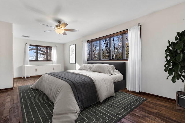 bedroom with ceiling fan and dark hardwood / wood-style flooring